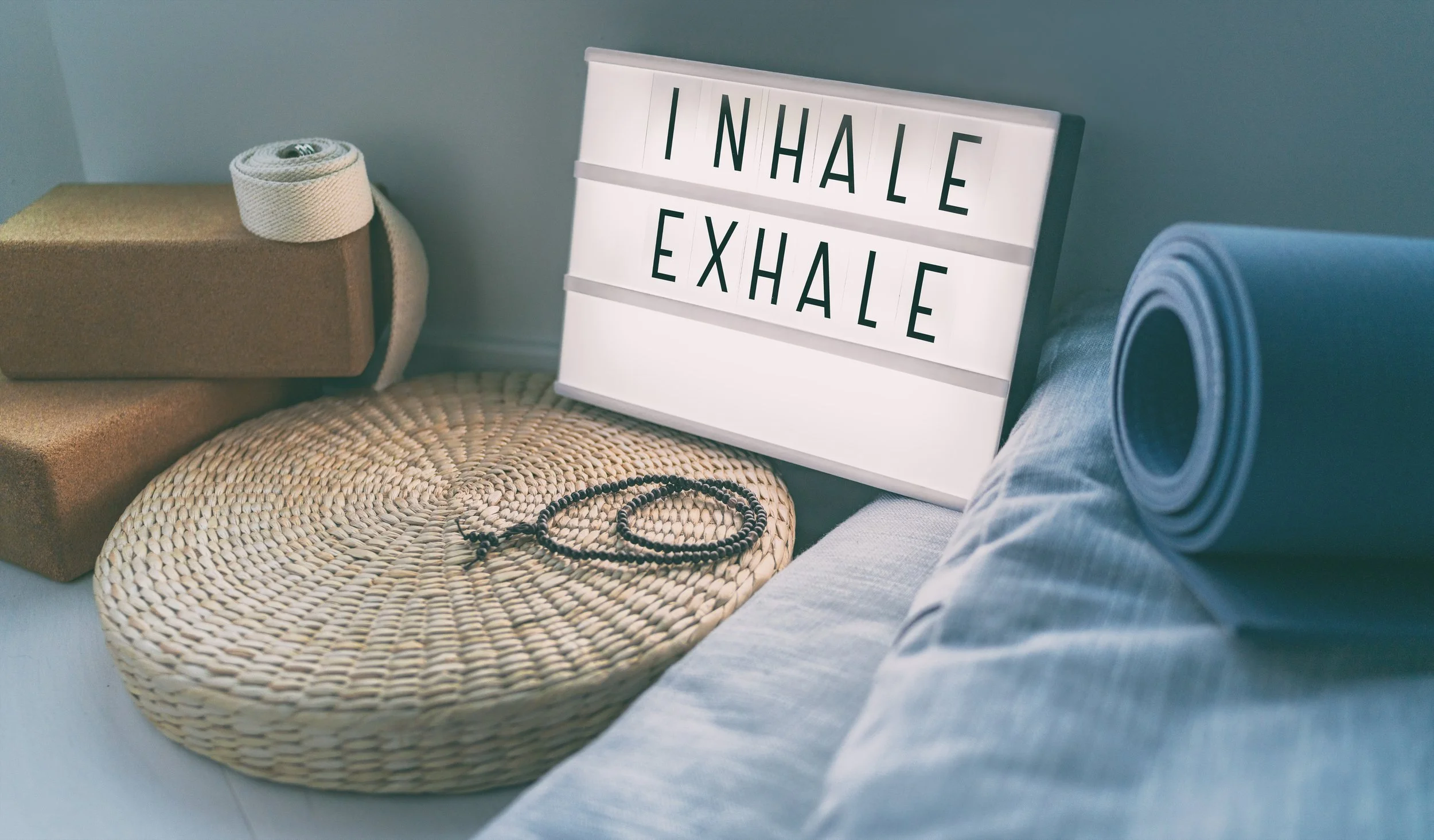 Breathwork props with an inhale exhale lightbox sign